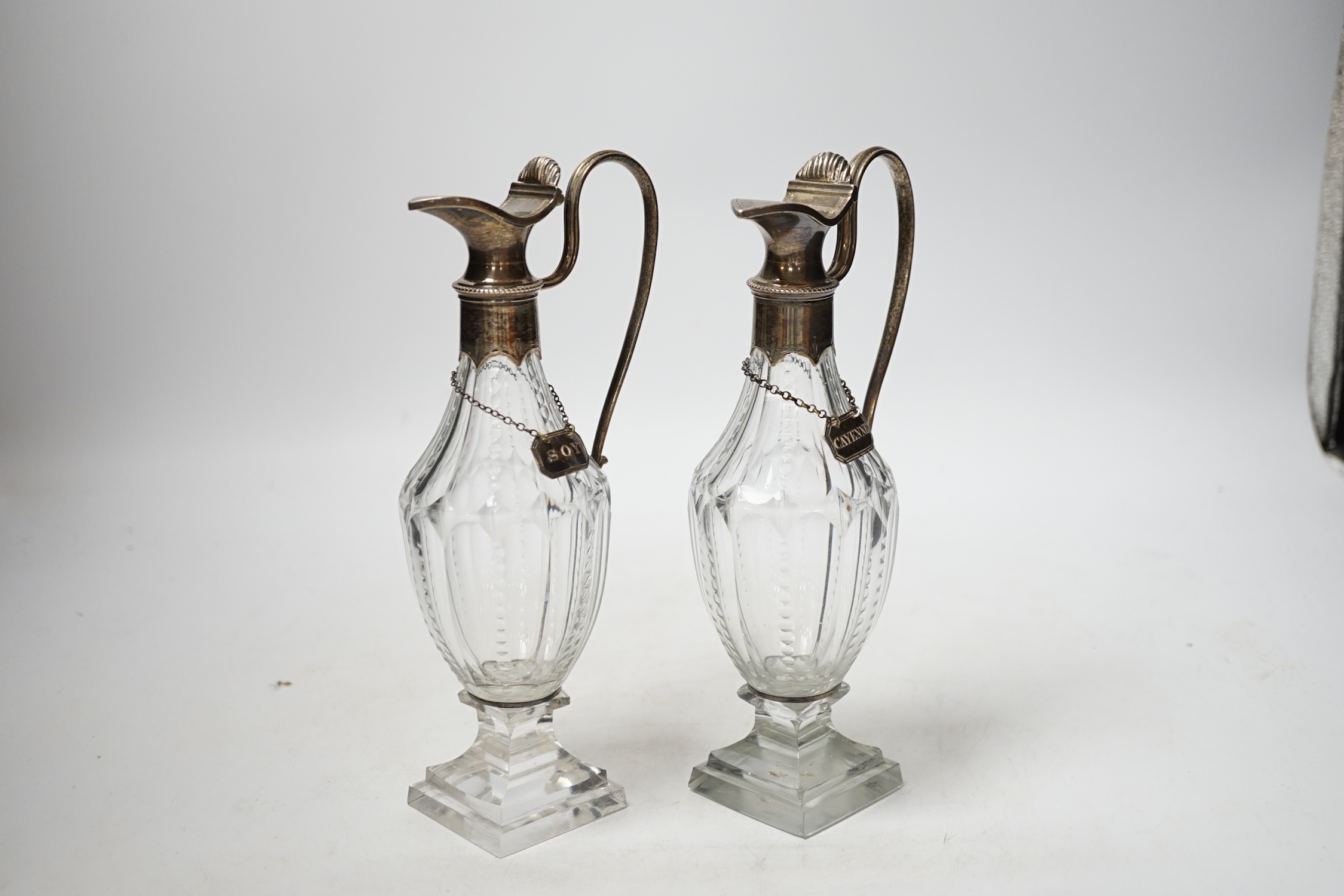 A pair of late 18th/early 19th century silver mounted cut glass cut glass cruet bottles with labels for Cayenne and Soy, makers mark only on mounts and labels for Phipps & Robinson, circa, 1800, height 20.5cm.